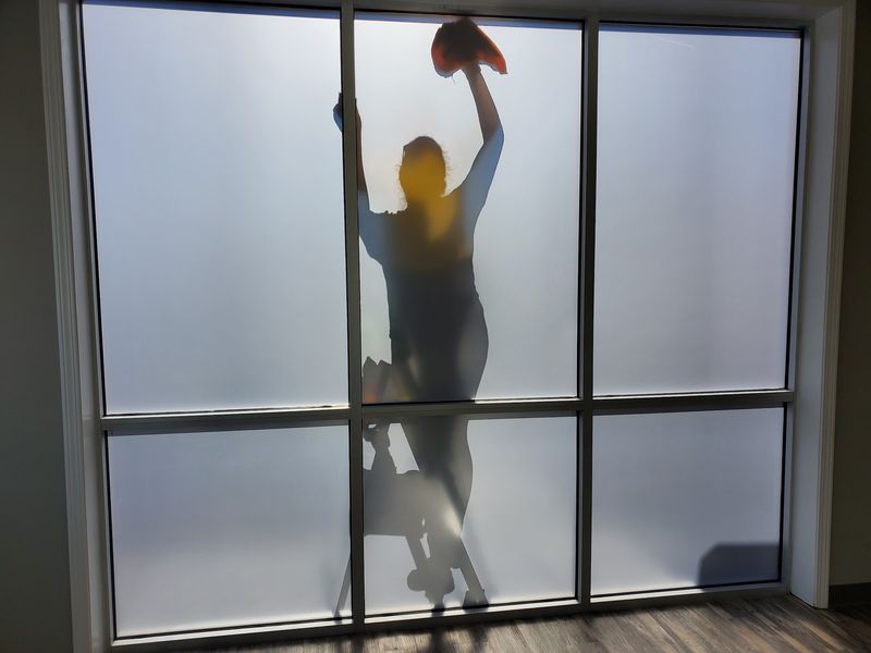 Cleaning a tall frosted-glass window